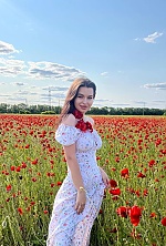 'I am standing in a field surrounded by bright poppies and enjoying this moment. Summer is my favorite time of year, when nature blooms in all its beauty. I love it when there are so many colors and life around.'